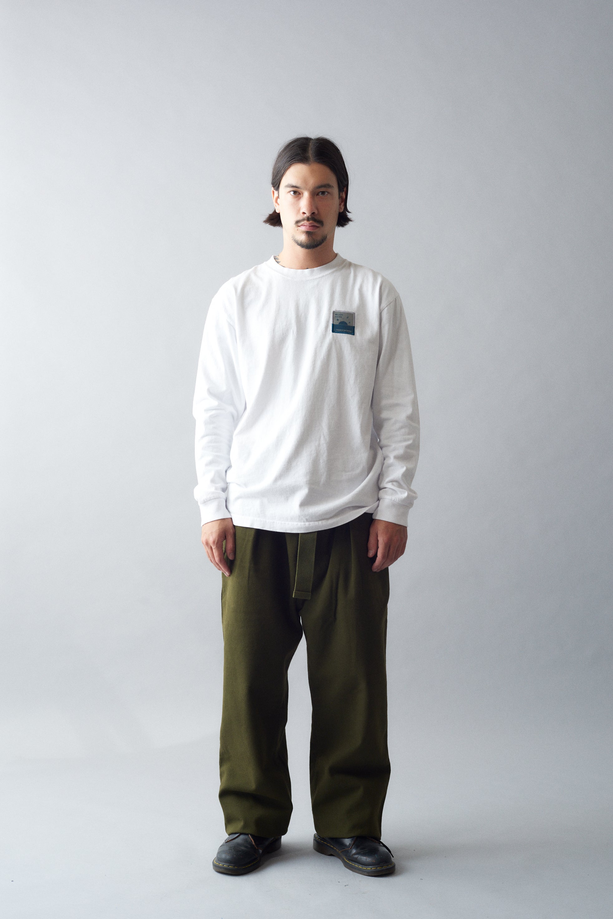 Man wearing MHL Cotton Wool Drill Slide Adjuster Trouser in urban setting