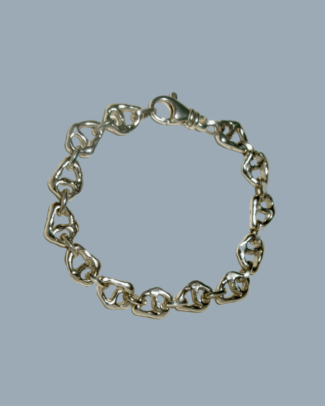 Silver chain bracelet on a gray background