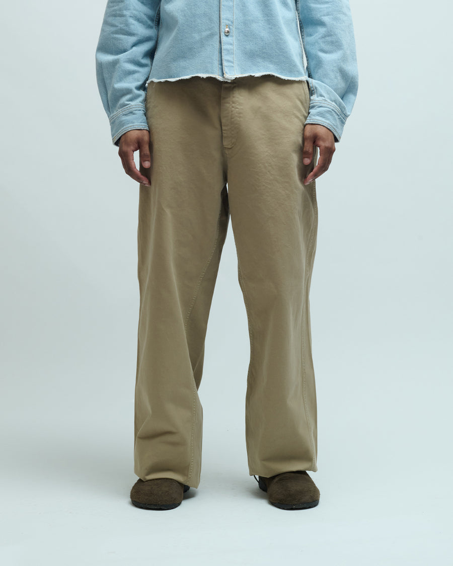 Khaki wide-leg chino pants with twisted inseam seam, front view on model
